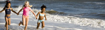 3 children running on beach
