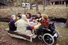woman in wheelchair with family at picnic