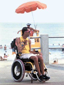 Man in wheelchair on boardwalk at Virginia Beach